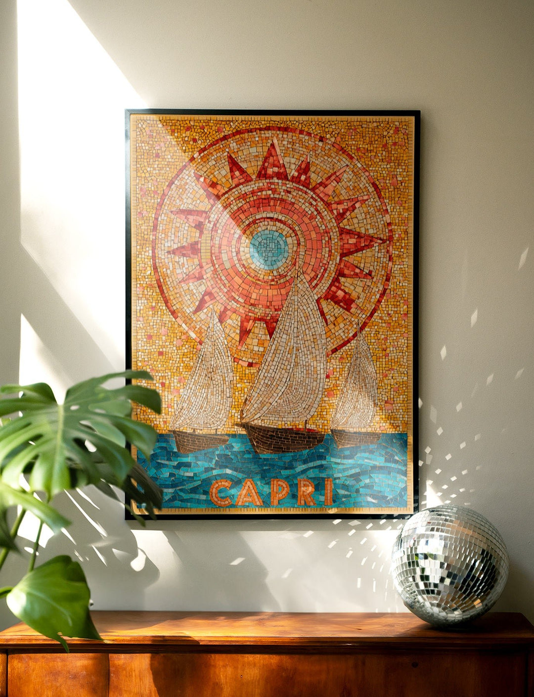 mosaic art of a ship with 'Capri' text on a wall with a plant and decorative ball.