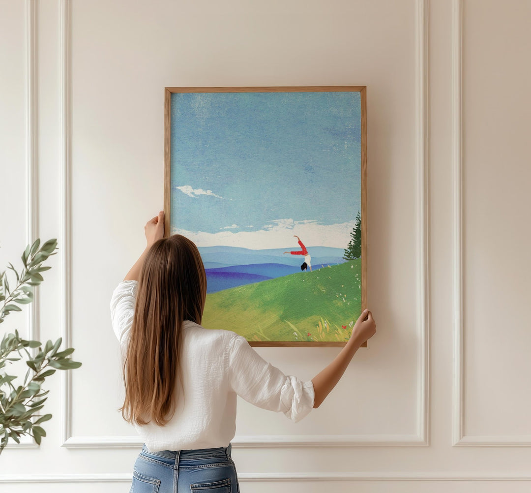 Girl holding an artwork on wall