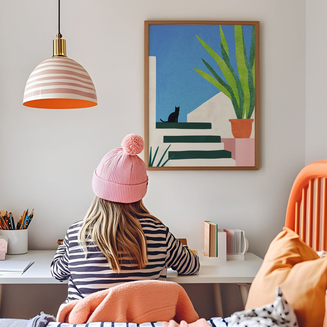 Girl studying in her room with artwork hanged on wall