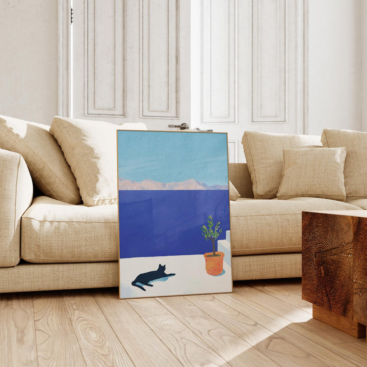 artwork on floor leaning against a white sofa