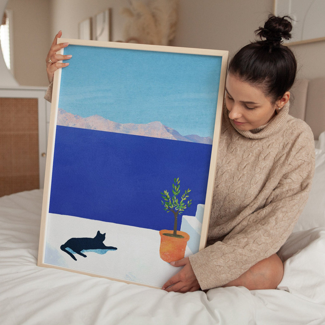 Girl on bed holding an artwork