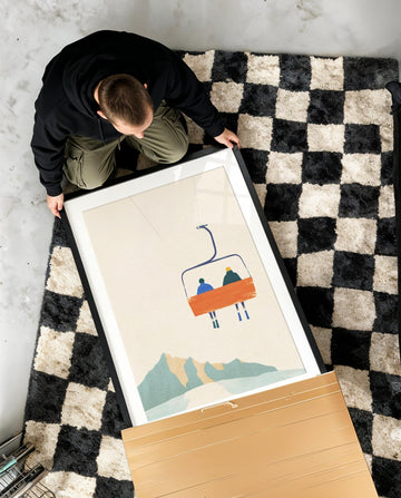 boy unboxing artwork on checkered rug