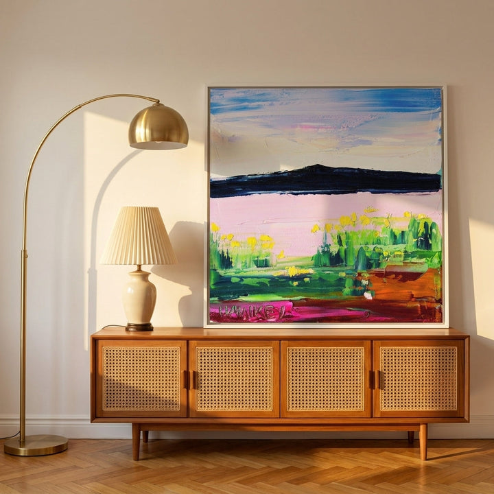 Canvas wall art with a white surround standing on a sideboard in a mid-century home office