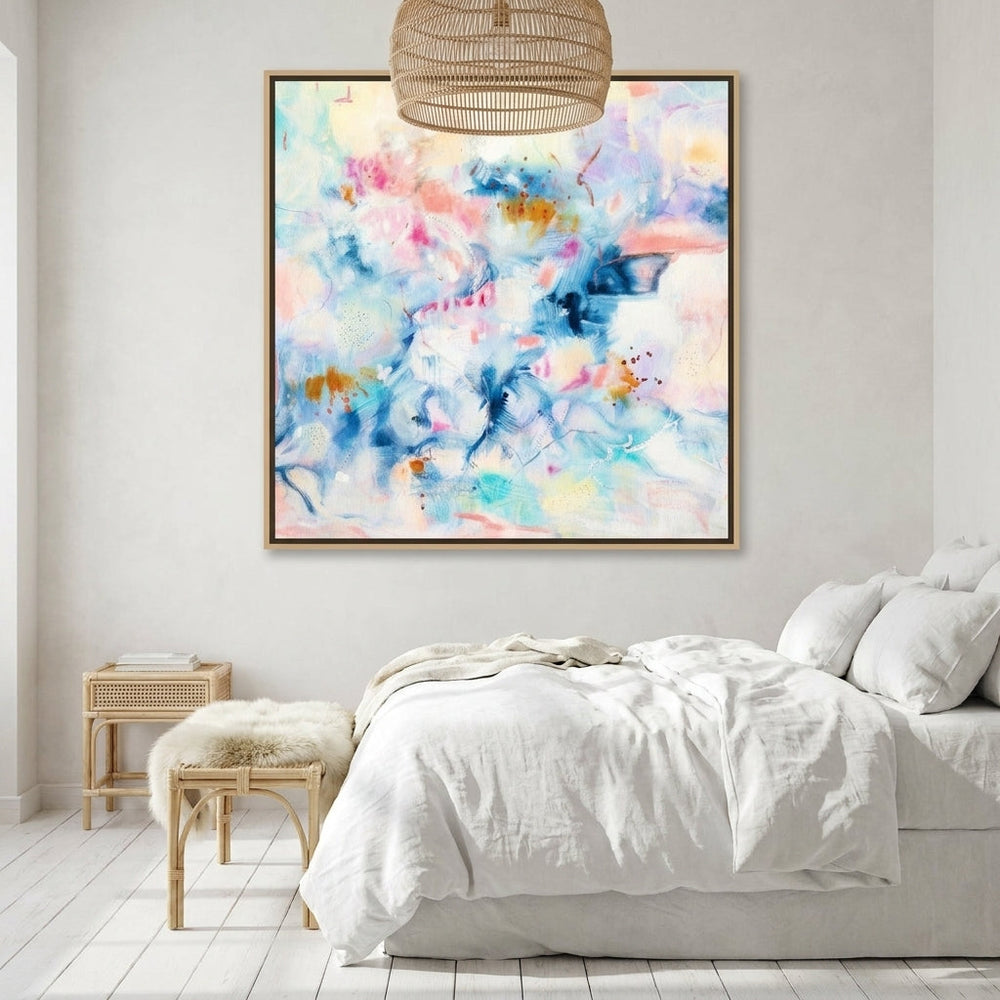 Oversized statement canvas wall art with a natural timber surround styled on the wall in a bright Scandinavian bedroom