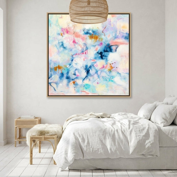 Oversized statement canvas wall art with a natural timber surround styled on the wall in a bright Scandinavian bedroom