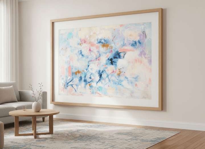 Modern wall art styled above a sofa in a neutral living room