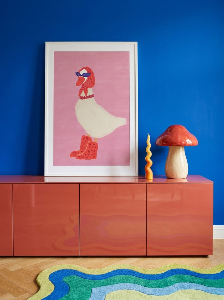 Modern wall art print standing on a sideboard in a colourful eclectic living room