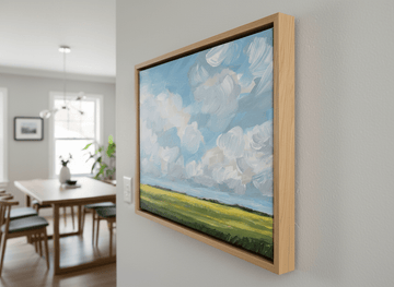 Wall art styled above a dining table in a contemporary home