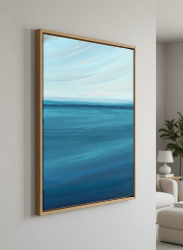 Modern wall art styled above a sofa in a neutral living room