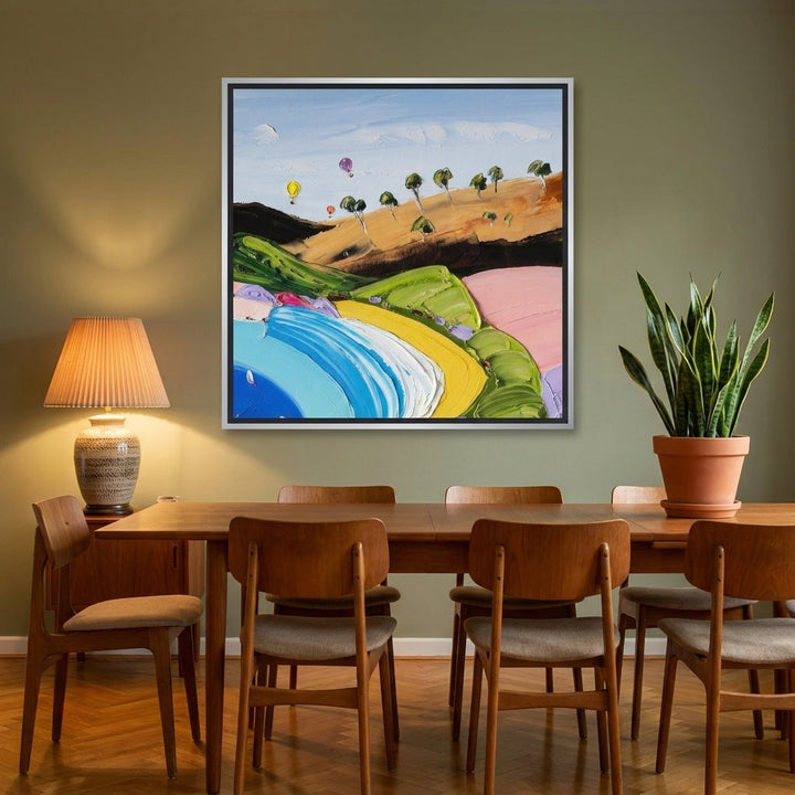 Canvas wall art with a silver leaf surround styled on the wall in a mid-century dining room