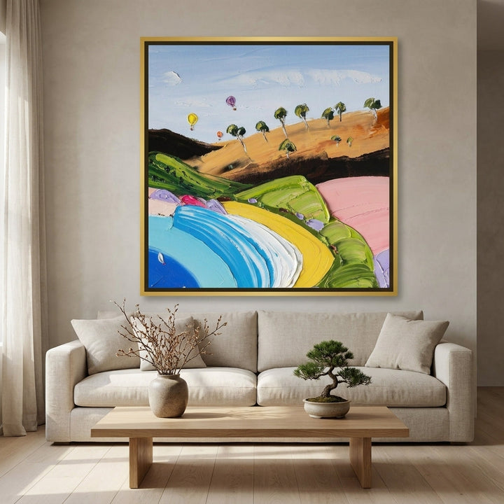 Oversized statement canvas wall art with a gold leaf surround styled on the wall in a warm Japandi living room