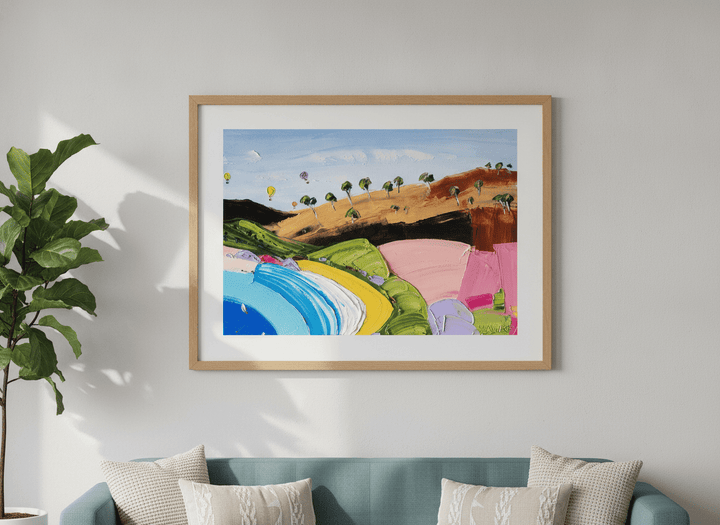 Modern wall art styled above a sofa in a neutral living room