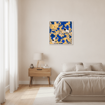 Canvas wall art with a white surround styled in a calm, light-filled bedroom