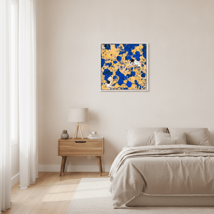 Canvas wall art with a white surround styled in a calm, light-filled bedroom