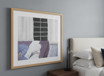 Minimalist artwork displayed in a calm, light-filled bedroom interior