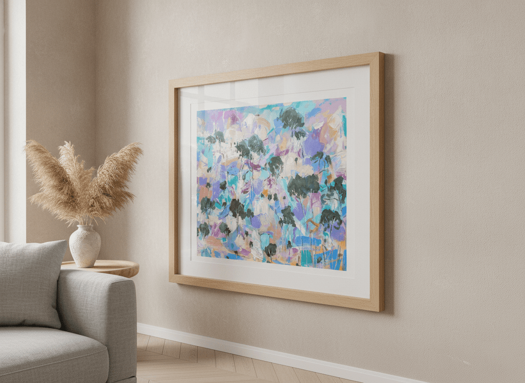 Modern wall art styled above a sofa in a neutral living room