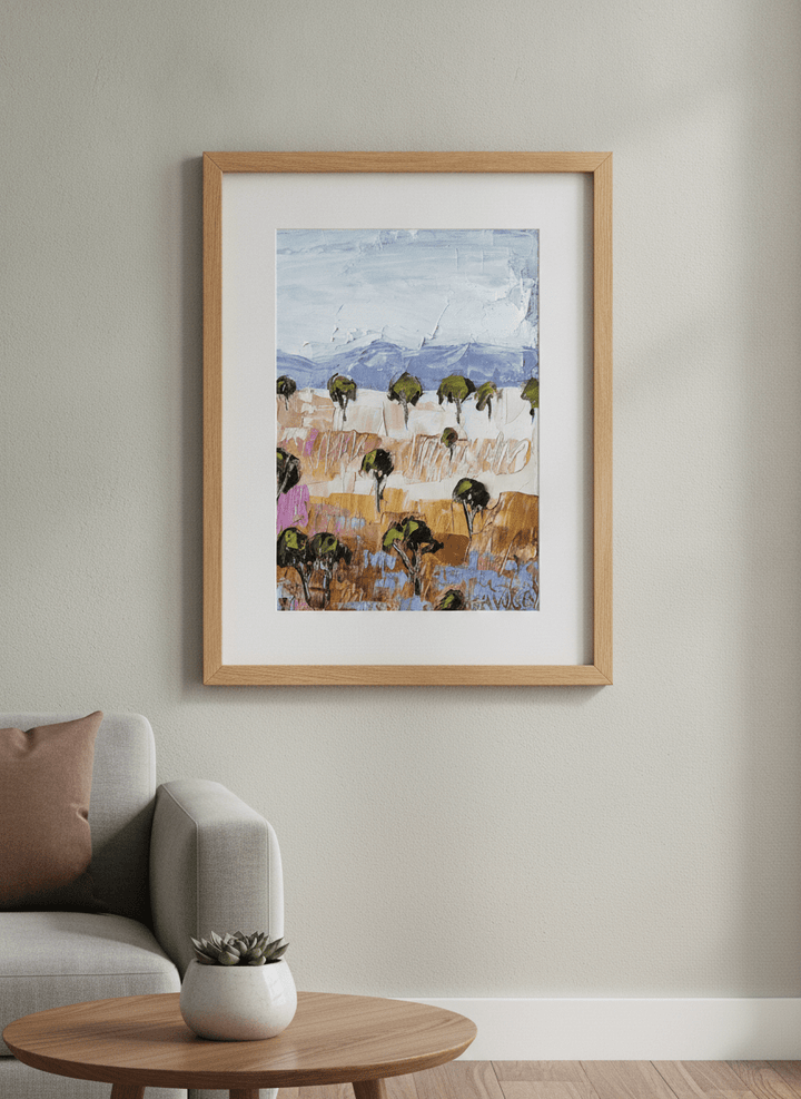 Modern wall art styled above a sofa in a neutral living room