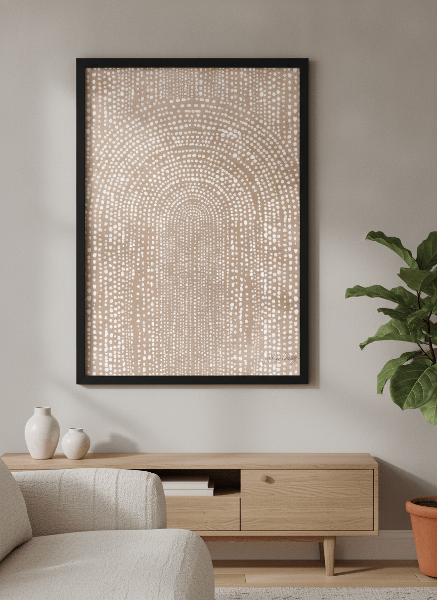 Modern wall art styled above a sofa in a neutral living room
