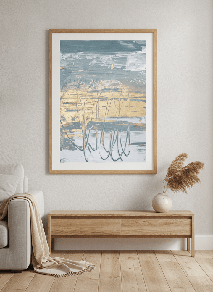 Modern wall art styled above a sofa in a neutral living room