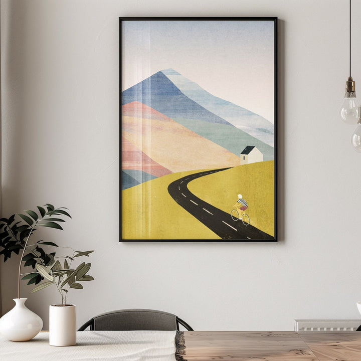 abstract landscape art above a wooden table in a room.