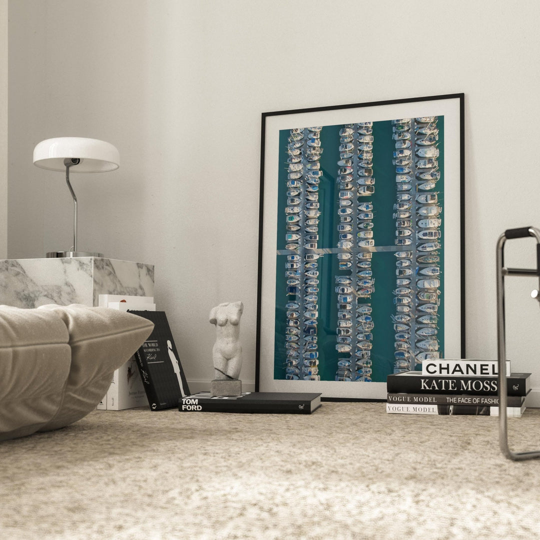 Abstract art piece on a shelf with books in a room setting.