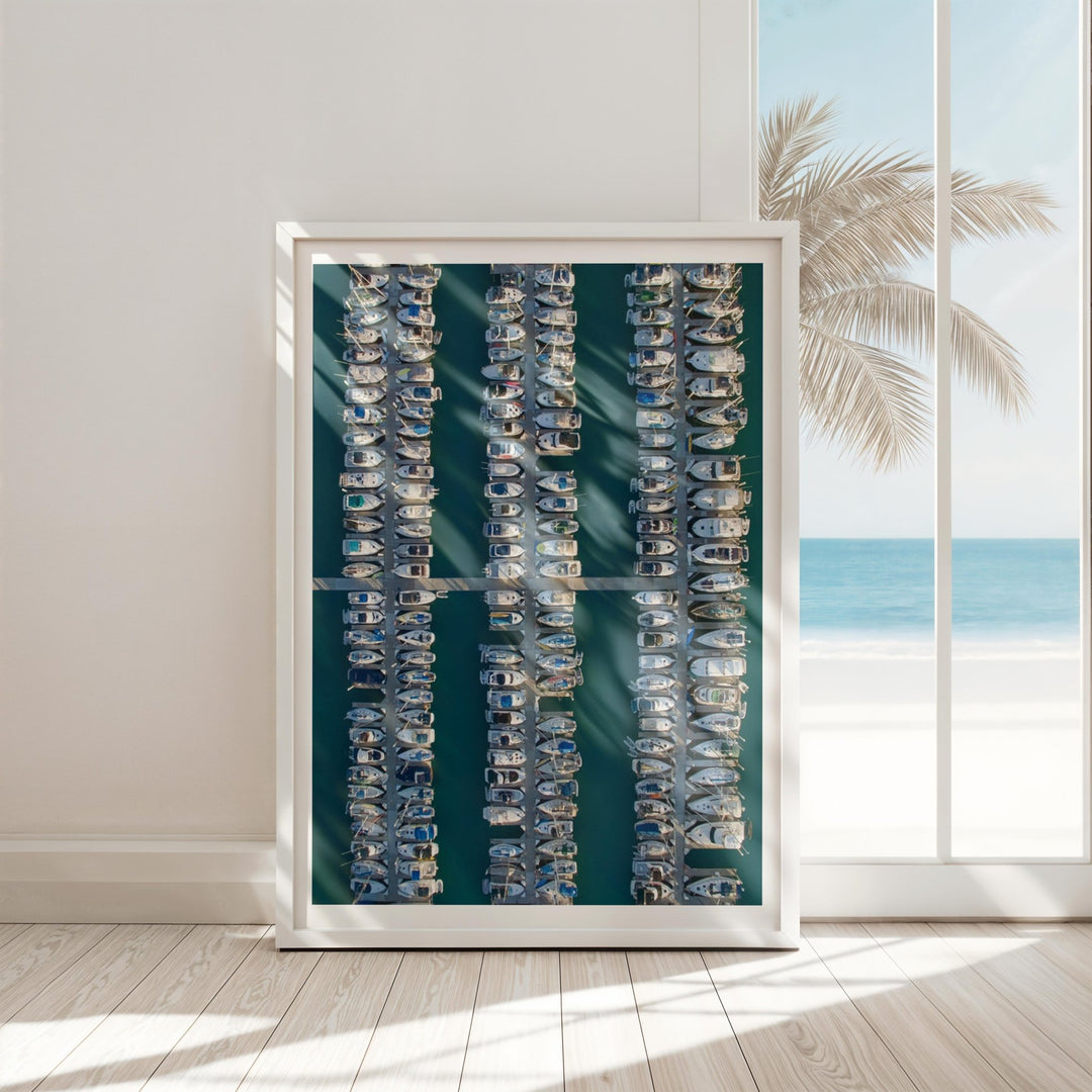 Artwork with palm tree and beach scene on a wall.