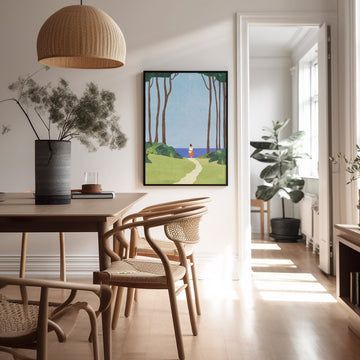 Dining room with wooden table and chairs, artwork on the wall, and natural light.