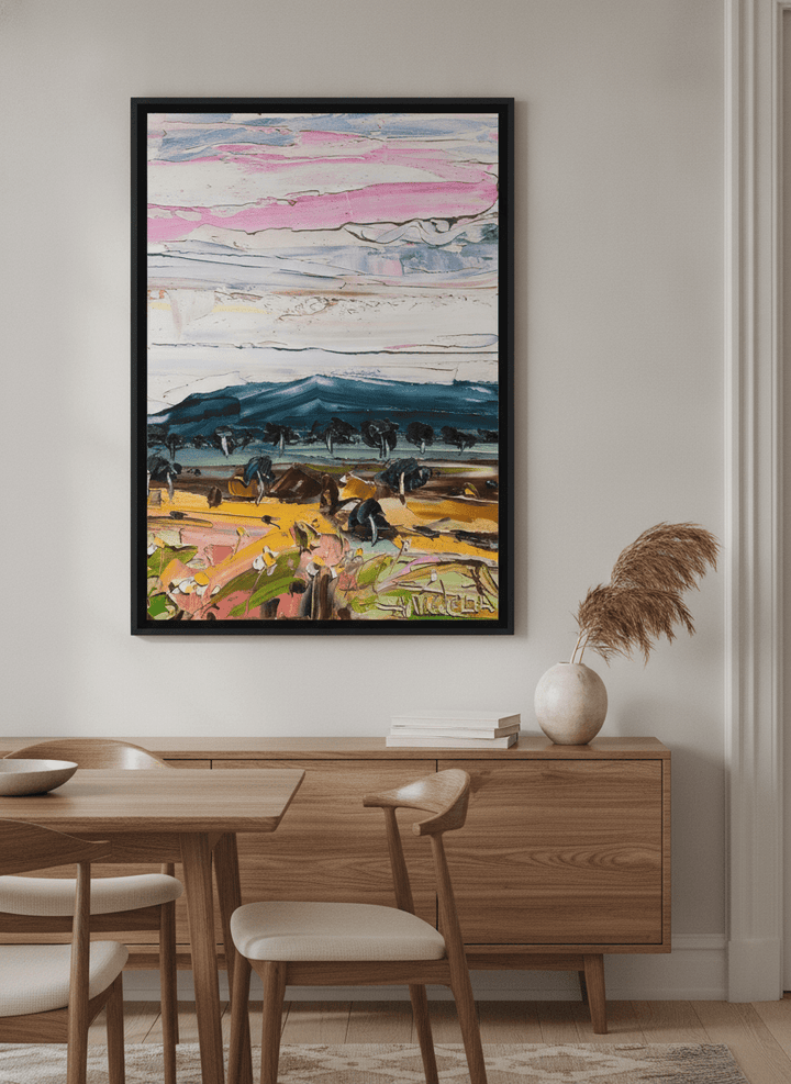Wall art styled above a dining table in a contemporary home