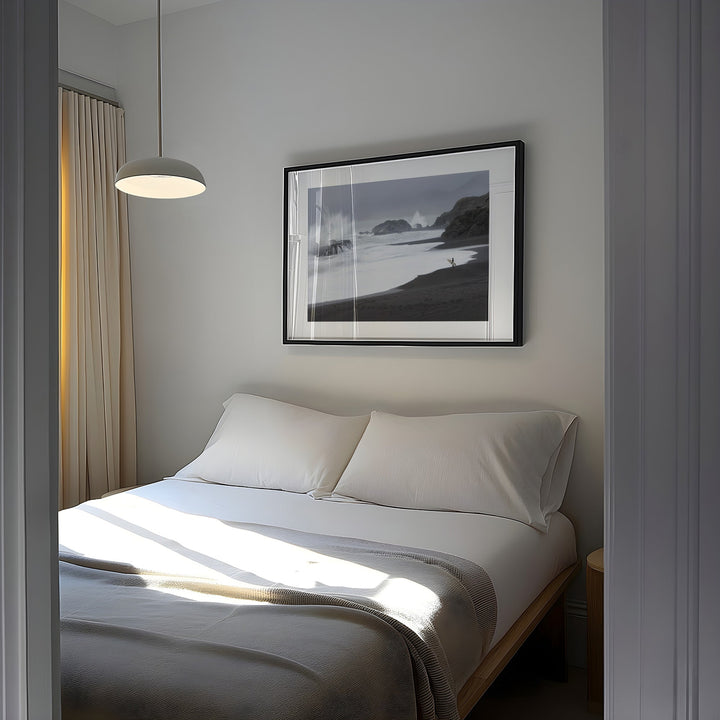 Bedroom with a bed and artwork on the wall