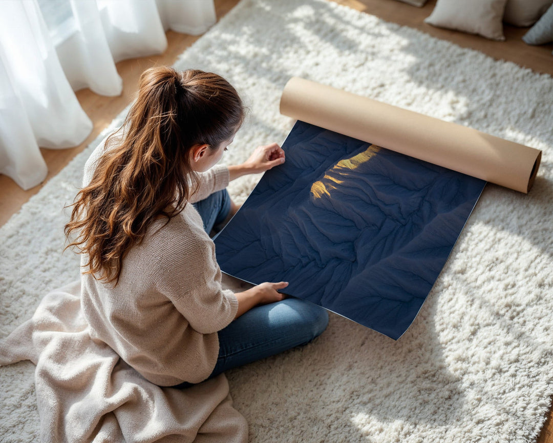 Woman unrolling a large piece of paper on a carpeted floor