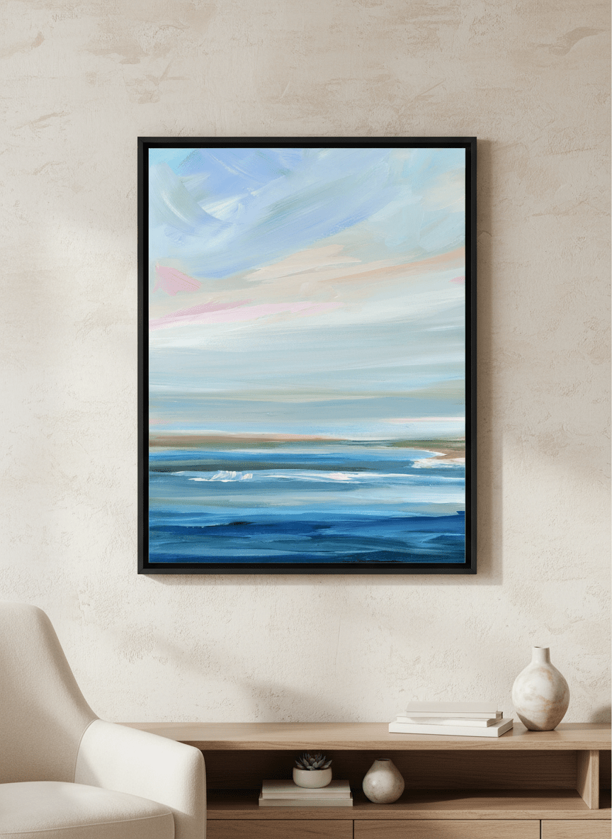 Modern wall art styled above a sofa in a neutral living room