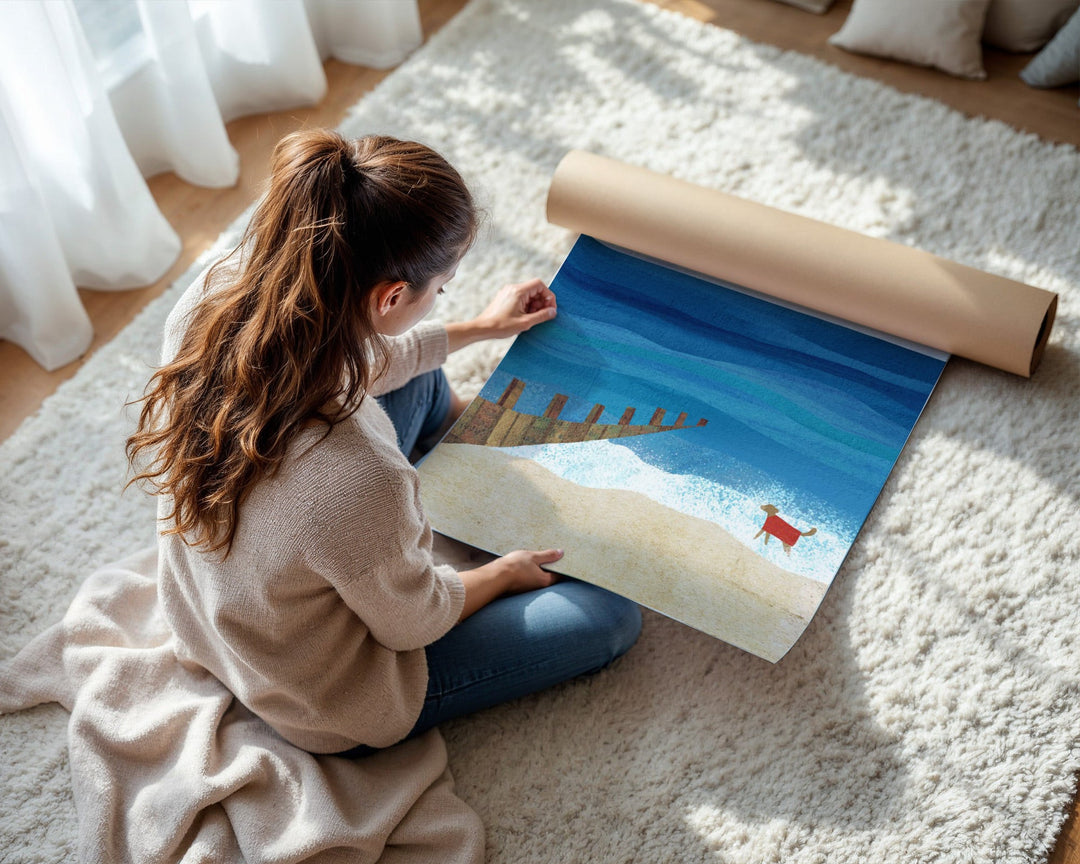 Woman unrolling a large scenic poster on a carpeted floor.