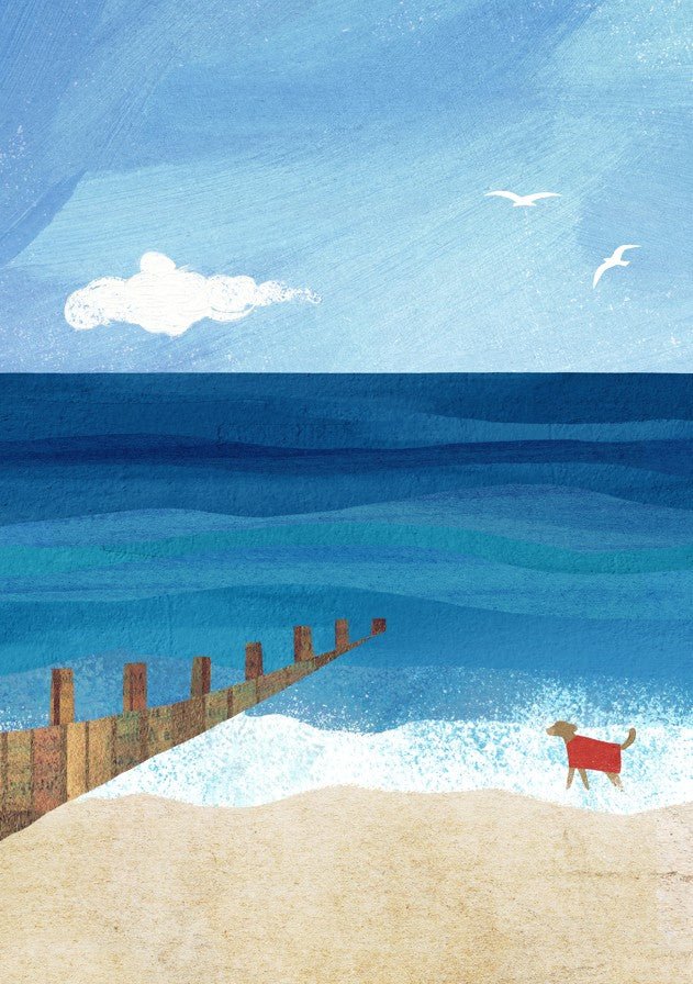 Dog with a red towel on a beach with a wooden pier and blue ocean. framed