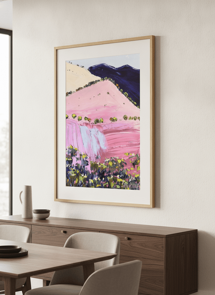Wall art styled above a dining table in a contemporary home