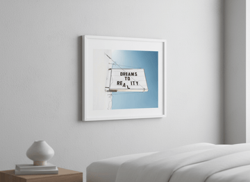 Minimalist artwork displayed in a calm, light-filled bedroom interior