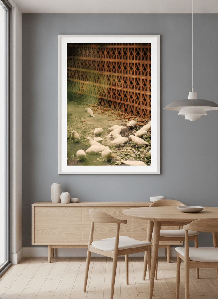 Wall art styled above a dining table in a contemporary home