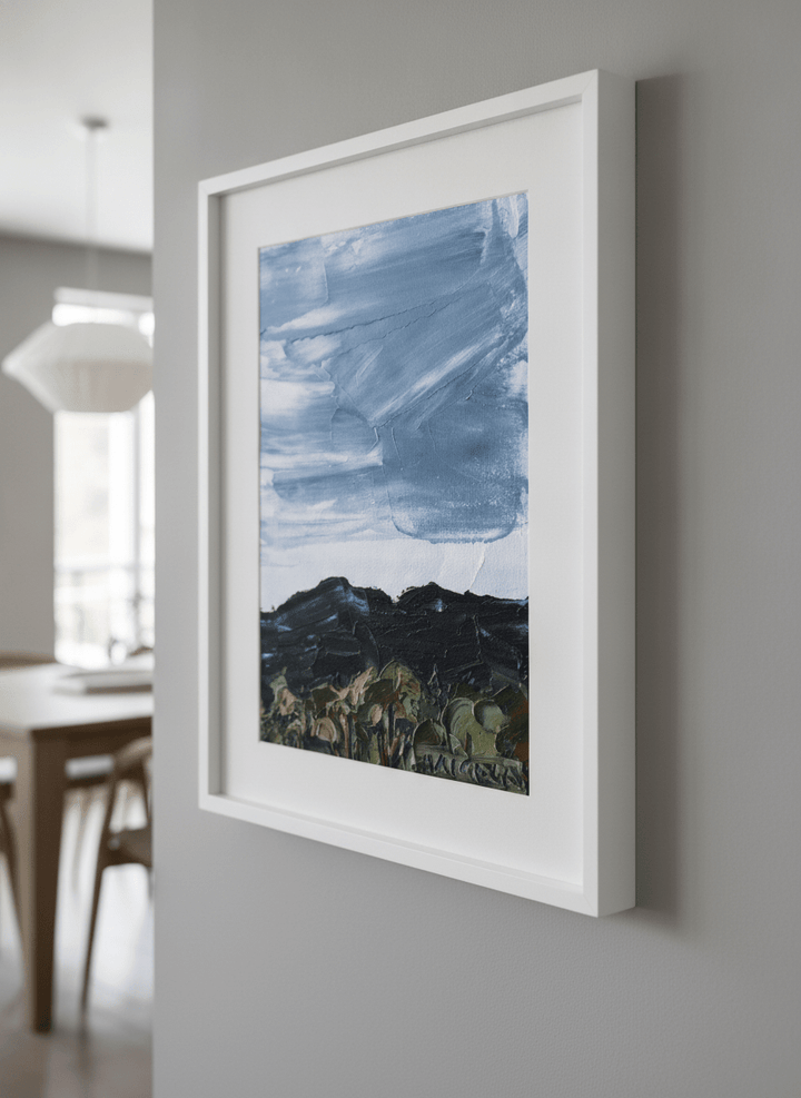 Wall art styled above a dining table in a contemporary home