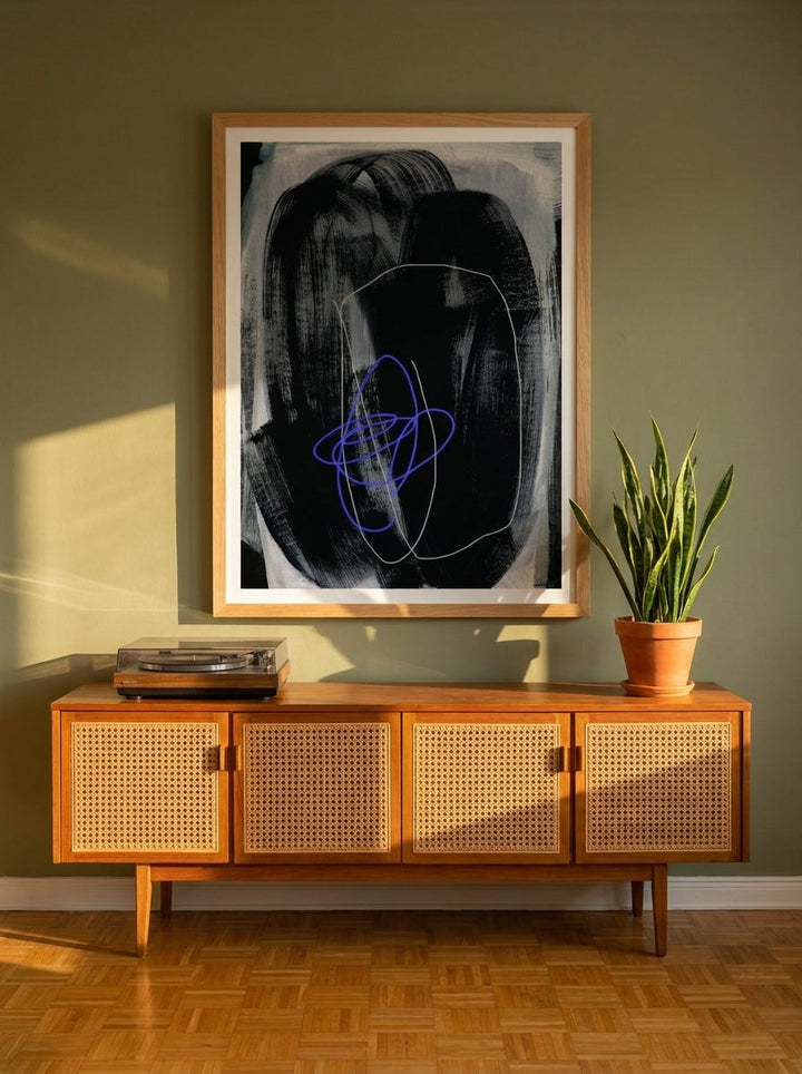 Modern wall art print styled on the wall in a mid-century living room