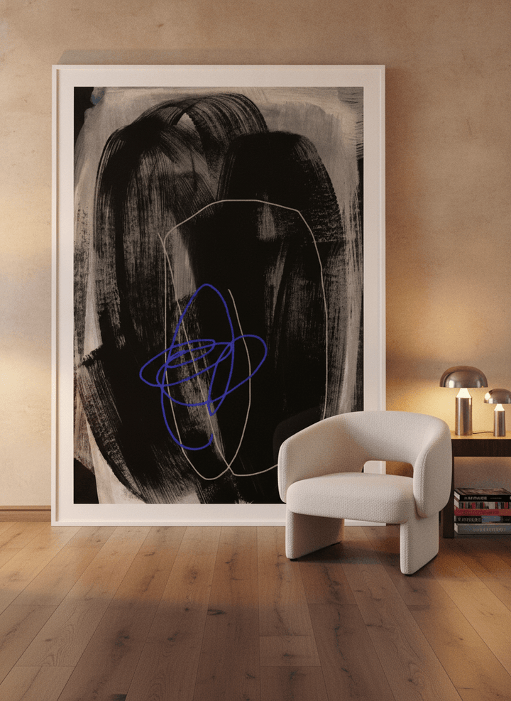 Oversized statement modern wall art print leaning against the wall in a luxe living room