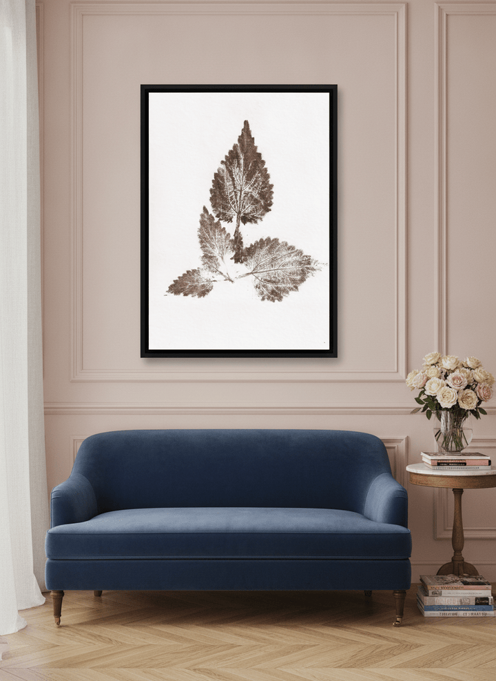 Canvas wall art with a black surround styled on the wall in a Parisian living room