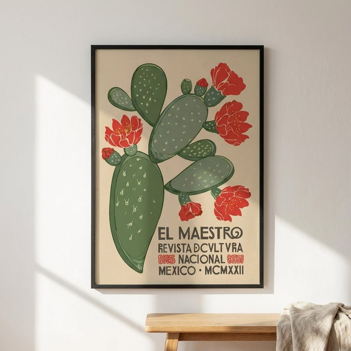 Framed poster with cactus and flowers on a beige background, displayed on a wall. 
