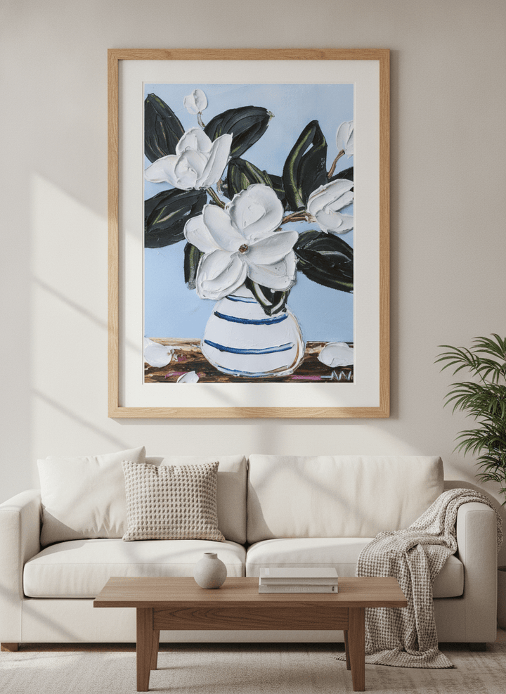 Modern wall art styled above a sofa in a neutral living room