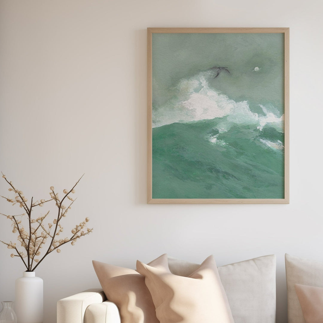 artwork of a green and white abstract design on a wall above a sofa.