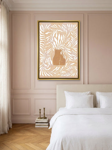 Canvas wall art with a gold leaf surround styled on the wall in a Parisian bedroom