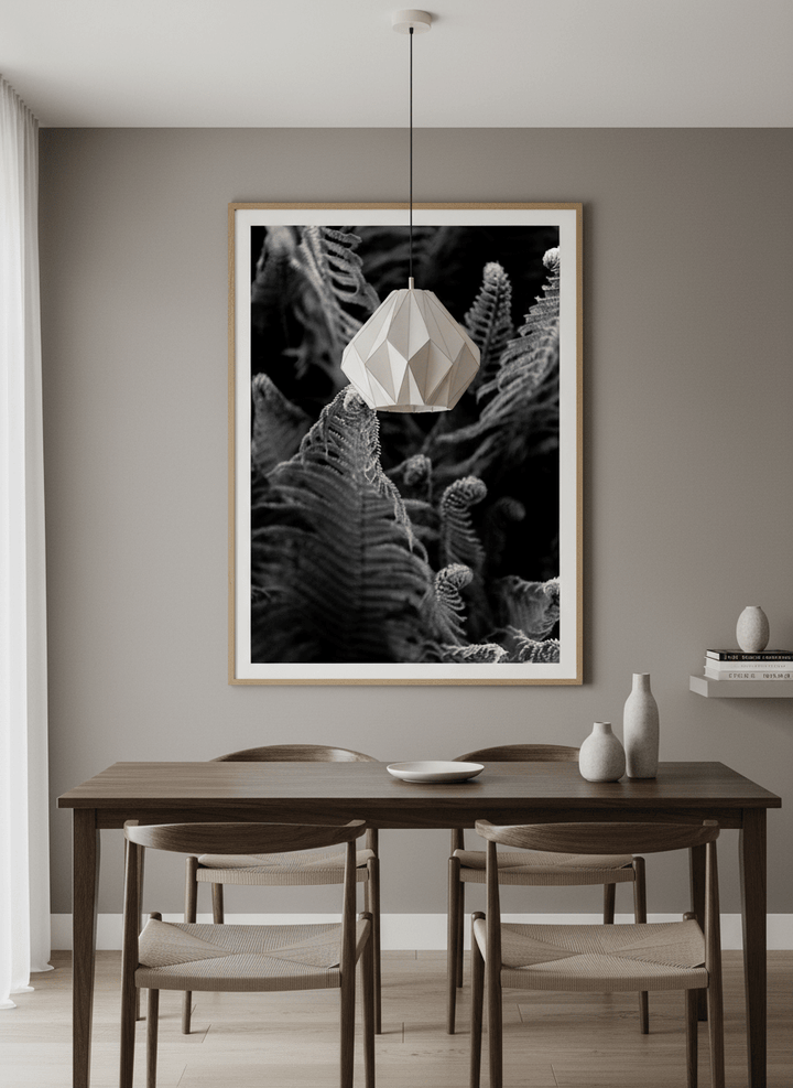 Wall art styled above a dining table in a contemporary home