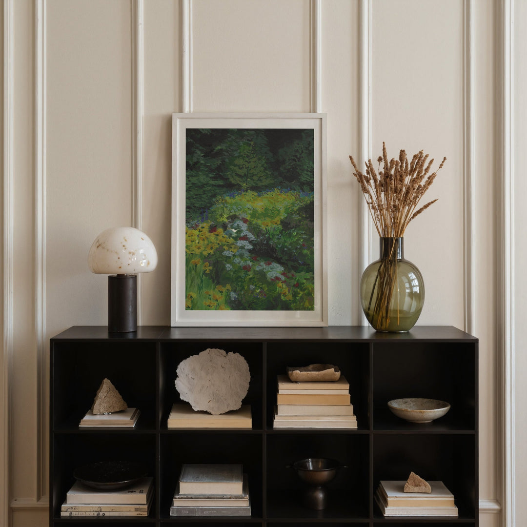 Decorative shelf with books, a vase, and a painting against a paneled wall.