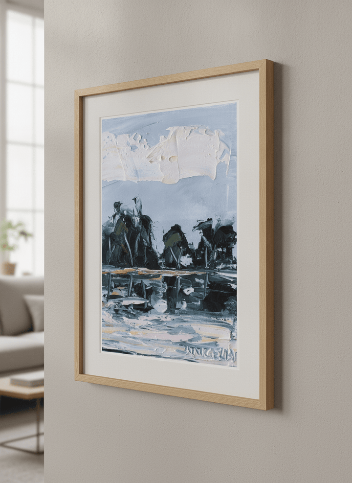Modern wall art styled above a sofa in a neutral living room