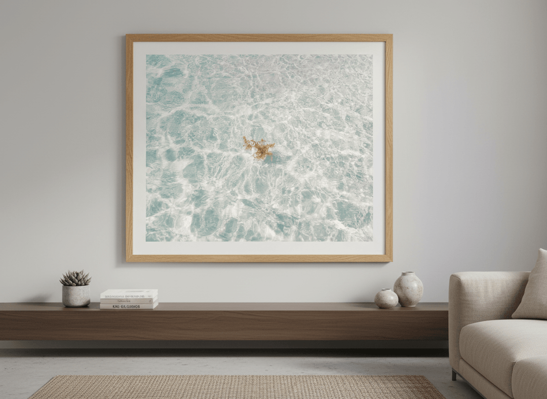 Modern wall art styled above a sofa in a neutral living room