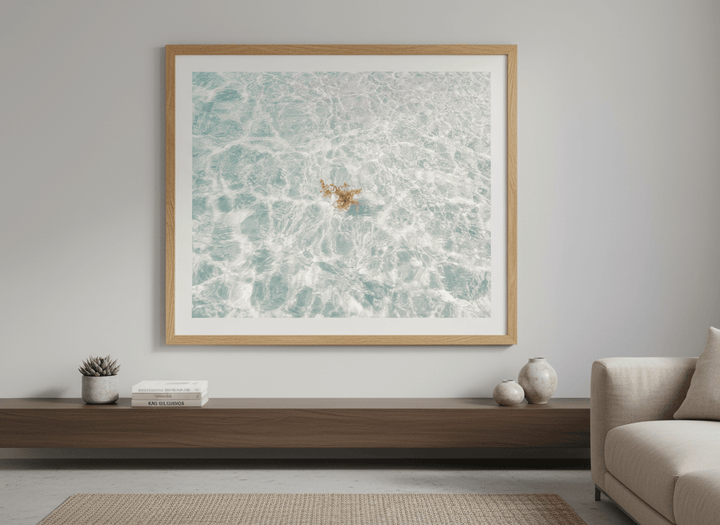 Modern wall art styled above a sofa in a neutral living room