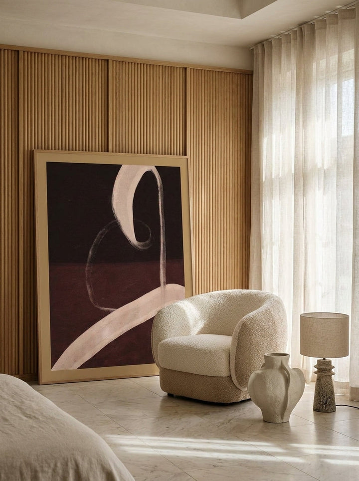 Oversized statement modern wall art print leaning against the wall in a luxe bedroom